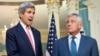 FILE - Secretary of State John Kerry, left, joined by Defense Secretary Chuck Hagel, speaks to media at the State Department in Washington, Oct. 24, 2014.