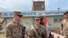 In this March 27, 2020 file photo, US soldiers stand guard during the handover ceremony of Qayyarah Airfield in the south of Mosul, Iraq.