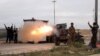 Imam Ali Brigades, members of of an Iraqi Shiite group, launch rockets against Islamic State extremist positions during clashes in Tikrit, 130 kilometers north of Baghdad, Iraq, March 24, 2015.
