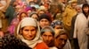 Kashmiris stand in queue to cast their votes outside a polling station during the first phase of voting to the Jammu and Kashmir state assembly elections in Hajan, 35 kilometers (21miles) north of Srinagar, Indian controlled Kashmir, Nov. 25, 2014.