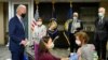 FILE - President Joe Biden, left, accompanied by officials, visits a COVID-19 vaccination site at the VA Medical Center in Washington, D.C., March 8, 2021.