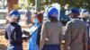 FILE - Police arrest a health worker during a protest against economic hardship and poor working conditions during the coronavirus disease (COVID-19) outbreak in Harare, Zimbabwe, July 6, 2020. 