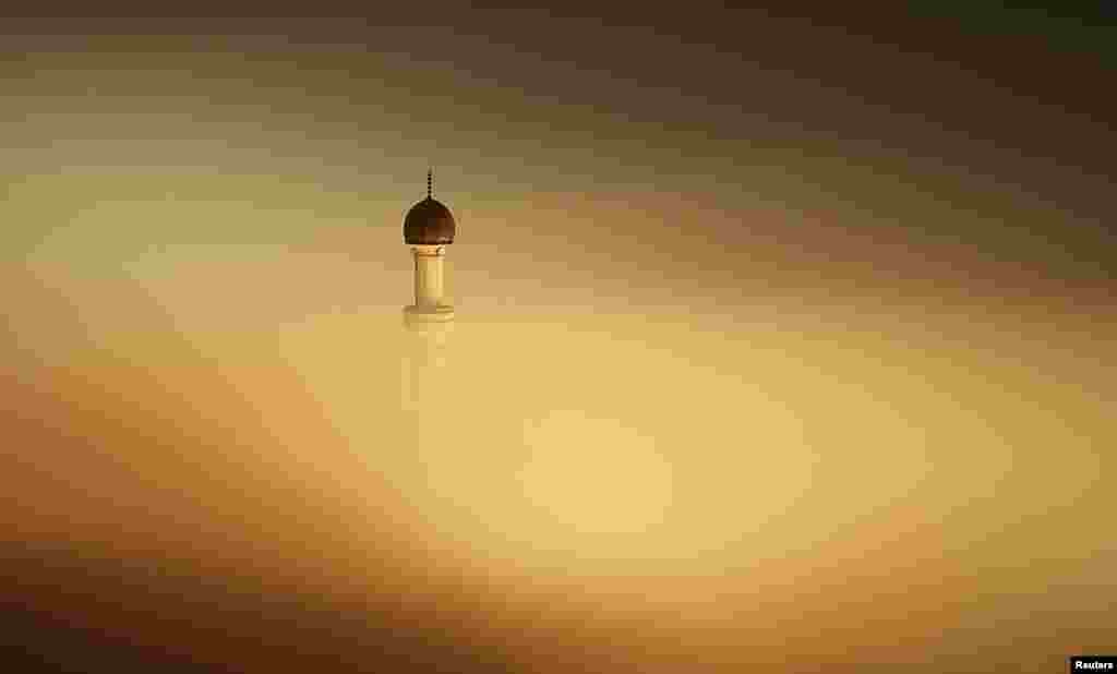 The minaret of a mosque is seen as smog blankets the village of Ponijeri, Bosnia and Herzegovina, Dec. 26, 2015.