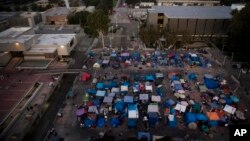 A large homeless encampment is formed on the "Plaza of the Flags" elevated park at the Santa Ana Civic Center complex, Oct. 11, 2017, in Santa Ana, California. 