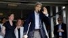 U.S. Secretary of State John Kerry waves after speaking to reporters as he is discharged from Massachusetts General Hospital in Boston, June 12, 2015.