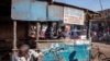 FILE - A butcher cuts meat at his shop on the streets of an open-air market on the outskirts of Lilongwe, Malawi, May 18, 2019. The government is looking to implement a 21-day coronavirus lockdown, which would close the country's large markets.