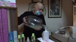 Chemist Ziya Melih Sezer, every week for decades, prepares cologne, which is now in high demand as a way of sterilizing hands to prevent COVID's spreading. (D. Jones/VOA)
