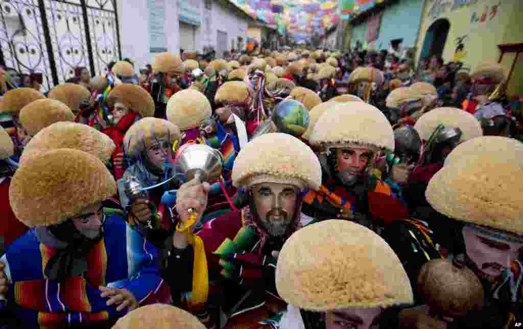 Traditional &quot;Parachicos&quot; dancers wearing wooden masks perform on the street during a Catholic celebration in Chiapas De Corzo, Mexico, Jan. 20, 2016.