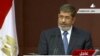 In this image made from a live broadcast on Egyptian State Television, Egyptian President Mohammed Morsi speaks to the constituent assembly in Cairo, Egypt, Dec. 1, 2012.