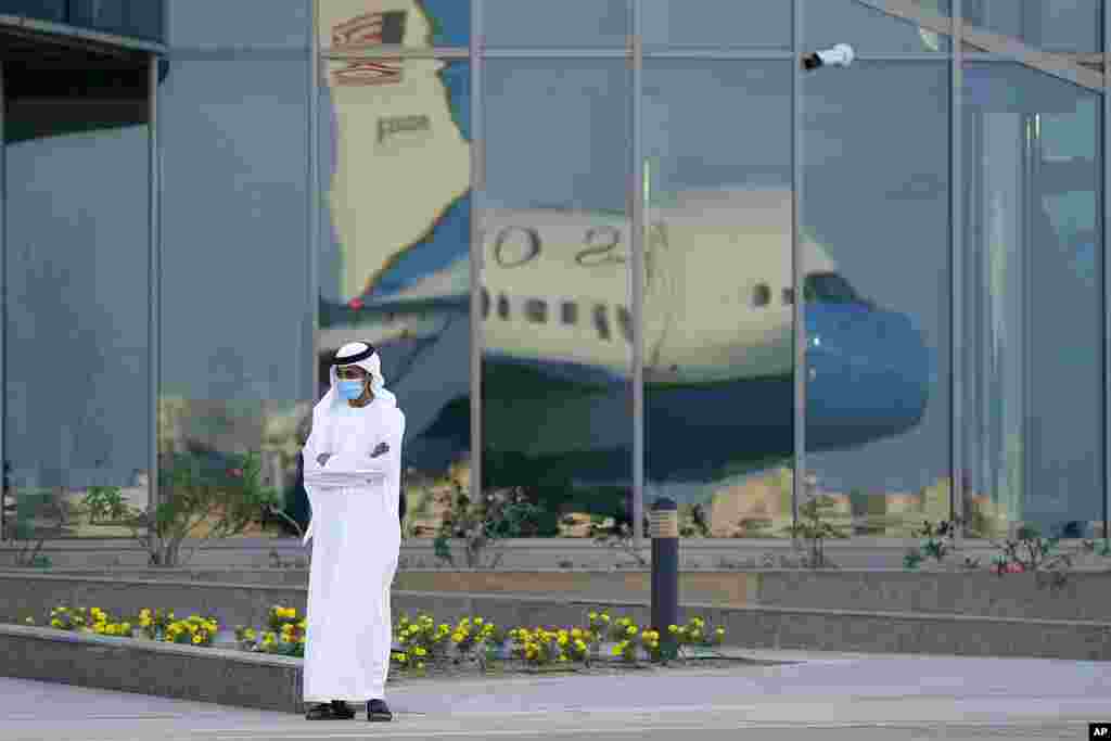 A man stands on a tarmac as Secretary of State Mike Pompeo&#39;s plane is reflected in windows at Al Bateen Executive Airport in Abu Dhabi, United Arab Emirates. Pompeo is visiting the United Arab Emirates as part of a trip to Europe and the Middle East.