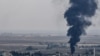 Fire and smoke rise from the Syrian town of Ras al-Ayn, Oct. 18, 2019.