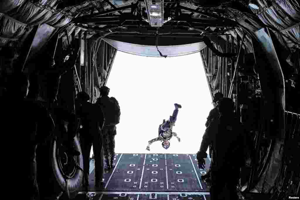 A soldier from Indonesia's Rapid Reaction Strike Force (PPRC) jumps from the back of an Air Force transport plane during a parachute training exercise in Tarakan, North Kalimantan province, in this photo taken by Antara Foto.