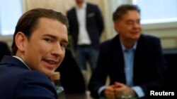 FILE - Austrian Conservative leader Sebastian Kurz, left, and Greens party chief Werner Kogler meet for coalition talks in Vienna, Austria, Nov. 15, 2019.