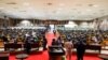 Pan African Parliament members gather in groups inside the house following its postponement in Midrand, Johannesburg on June 1, 2021.