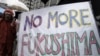 A demonstrator holds a "No more Fukushima" sign during a rally, protesting against restarting the Ohi nuclear power plant's reactors in front of the prime minister's official residence in Tokyo, Saturday, June 16, 2012.