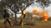 Members of Syria's opposition National Liberation Front fire heavy artillery guns at government forces in the village of Talhiyeh near the town Taftanaz in northeastern Idlib province, Feb. 28, 2020. 