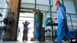 FILE - Suspected illegal immigrants are being processed at the Tucson Sector of the U.S. Customs and Border Protection headquarters in Tucson, Arizona, Aug. 9, 2012.
