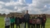 Yazidi children, recently freed from the Islamic State group, are pictured with their aid worker, near Hasaka, Syria, Feb. 27, 2019. (J. Jendo/VOA) 