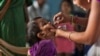 FILE - An Indian medical volunteer administers a dose of polio vaccine to a child in Hyderabad, India, Jan. 29, 2017.