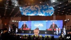 Prime Minister Benjamin Netanyahu addresses his supporters after the first exit poll results for the Israeli parliamentary elections at his Likud party's headquarters in Jerusalem, March 24, 2021. 