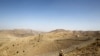 FILE - A soldier stands guard along the border fence outside the Kitton outpost on the border with Afghanistan in North Waziristan, Pakistan, Oct. 18, 2017.