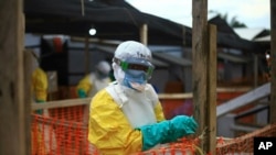 FILE - An Ebola health worker is seen at a treatment center in Beni, Eastern Congo, April, 16, 2019. 