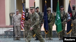 FILE - Commander of NATO Resolute Support forces and United States forces in Afghanistan, U.S. Army General John Nicholson walks during a change of command ceremony in Resolute Support headquarters in Kabul, Afghanistan, March 2, 2016.