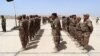 FILE - Sunni tribesmen attend a ceremony to present them with weapons at Camp Habbaniyah, Iraq, April 8, 2015.