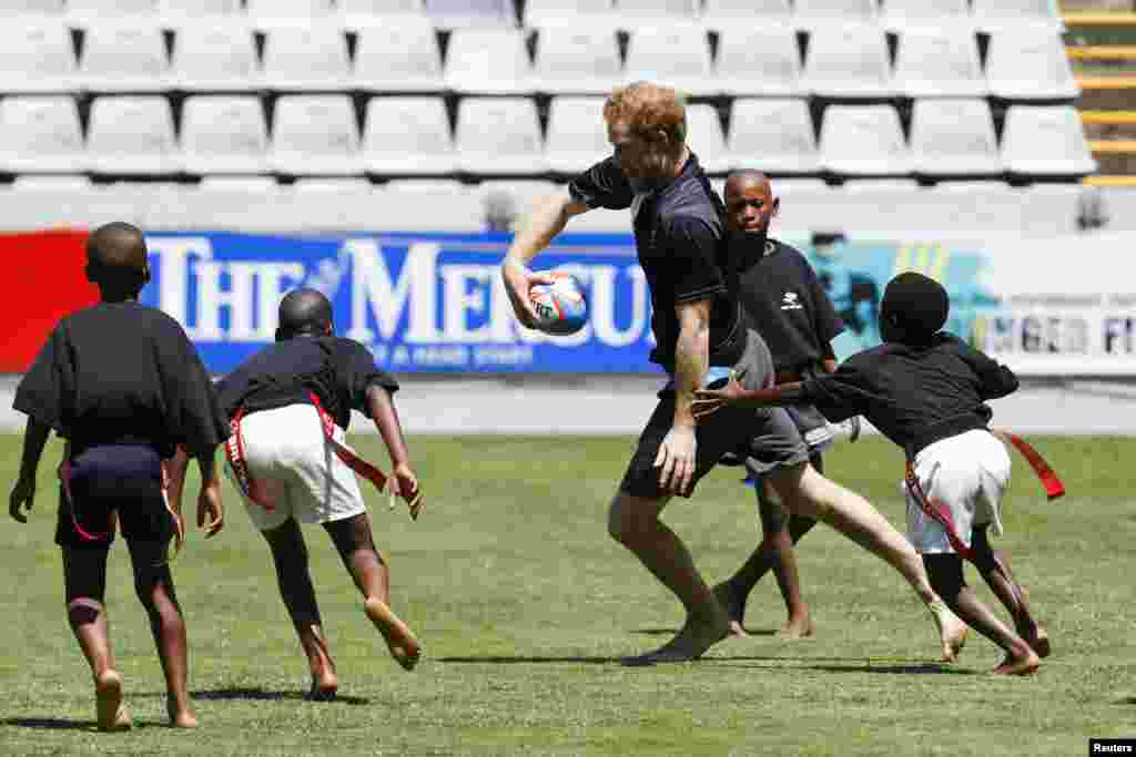 Britain's Prince Harry plays Tag rugby with local kids during a training session in Durban, South Africa. Prince Harry is in South Africa on behalf of Sentebale, the charity he founded with Lesotho's Prince Seeiso in memory of their mothers.