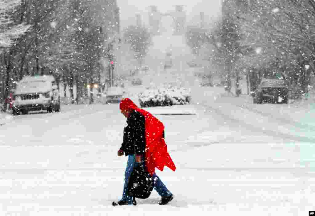 A man walks through heavy snow in downtown Nashville, Tennessee. Much of downtown was deserted as state and city government offices were closed for the day.&nbsp; A major winter storm is hitting much of the Eastern part of the U.S. and also affecting the Midwest and South.&nbsp; &nbsp;