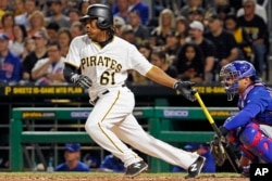 Pittsburgh Pirates' Gift Ngoepe, a native of South Africa, and the first baseball player from the continent of Africa to play in the Major Leagues, hits a single off Chicago Cubs starting pitcher Jon Lester in his first at-bat in the fourth inning of a baseball game in Pittsburgh, April 26, 2017.