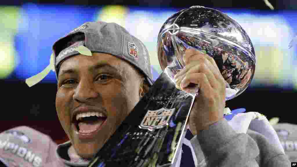 Seattle Seahawks' player holds the Lombardi Trophy after the NFL Super Bowl XLVIII football game