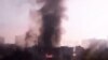 In this image taken from video obtained from the Syria 2011 Archives, which has been authenticated based on its contents and other AP reporting, black smoke rises from Syria's army command headquarters in Damascus, Syria, on Sept. 26, 2012. 