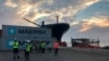 Workers stand in front of shipping containers at the Port of Berbera, run by DP World, which is majority-owned by the Dubai government in the UAE, in Berbera, Somaliland, Somalia, April 1, 2018.