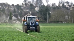 Cereal farmer Jerome Regnault in his tractor in Plaisir, outside of Paris. He says working in his business needs experience. (Lisa Bryant/VOA)