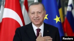FILE PHOTO: Turkish President Tayyip Erdogan reacts ahead of a meeting with EU Council President Charles Michel in Brussels, Belgium March 9, 2020.