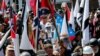 FILE - White nationalist demonstrators walk into Lee Park in Charlottesville, Virginia, Aug. 12, 2017.