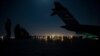 In this image provided by the US Air Force, aircrew prepare to load qualified evacuees aboard a C-17 Globemaster III aircraft in support of the Afghanistan evacuation at Hamid Karzai International Airport, Kabul, Afghanistan, Aug. 21, 2021.