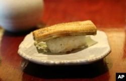 FILE - A dish of eel nigiri is served at Miyake, a Japanese restaurant, in Portland, Maine, July 20, 2017.