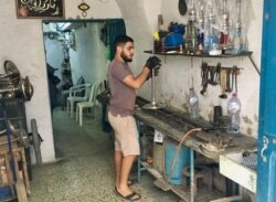 A man making water pipes. The Medina's artisans have declined sharply over the past half century. (VOA/ Lisa Bryant)