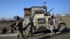 FILE - Security personnel arrive near the site of a suicide bombing near the Bagram Air Base in Parwan province of Kabul, Afghanistan, Dec. 11, 2019. The Bagram Air Base is the main American base north of the capital Kabul, the U.S. military said.