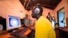 FILE - Young men surf the internet at a cybercafe on June 20, 2012, in the Kibera division of Nairobi. 