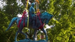 Workers remove the monument of Confederate Gen. Robert E. Lee, July 10, 2021, in Charlottesville, Va. The removal of the Lee statue followed years of contention, community anguish and legal fights.