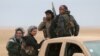 FILE - Syrian Democratic Forces fighters ride on a vehicle near Raqqa, Feb. 5, 2017. The U.S.-backed troops have made significant advances.