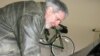 Volt owner Jeff Parmet disconnects the power cord from his new electric car.