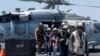 Sailors from the Dwight D. Eisenhower Carrier Strike Group assist mariners rescued from the Liberian-flagged, Greek-owned bulk carrier M/V Tutor that was attacked by Houthis, in the Red Sea, June 15, 2024. (U.S. Naval Forces Central Command/U.S. 5th Fleet/Handout via REUTERS) 