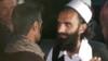 A newly freed Taliban prisoner greets his relatives outside Bagram prison, north of Kabul, Afghanistan, April 8, 2020. 