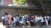 ປະ​ຊາ​ຊົນ​ລໍ​ຖ້າ​ໃນ​ແຖວ​ເພື່ອ​ເຂົ້າ​ຂໍ​ວີ​ຊາ​ໃນ​ສະ​ຖານ​ທູດ​ ໄທ, ນະ​ຄອນ ຢາງ​ກຸ້ງ, ມຽນ​ມາ, 20 ກຸມ​ພາ 2024.