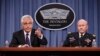 Defense Secretary Chuck Hagel, left, accompanied by Joint Chiefs Chairman Gen. Martin Dempsey brief reporters about ongoing operations against Islamic extremists in Syria and Iraq during a news conference at the Pentagon.