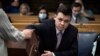 Kyle Rittenhouse pulls numbers of jurors out of a tumbler during his trial at the Kenosha County Courthouse in Kenosha, Wisconsin, Nov. 16, 2021.